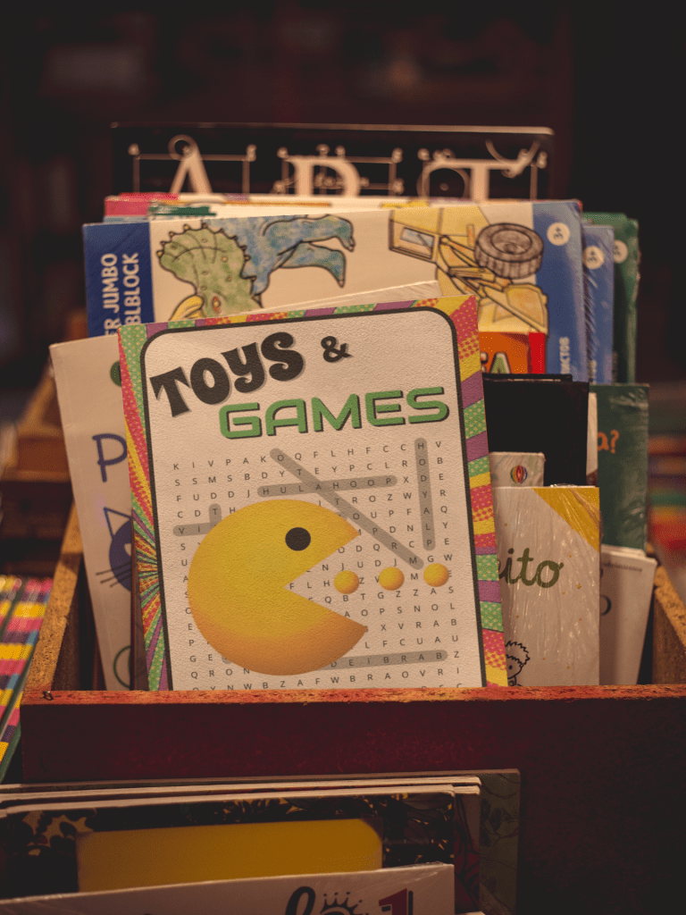 Toys and Games Word Search book sits in a box of books